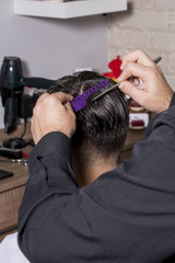 Hairdresser cutting a client's hair with a razor