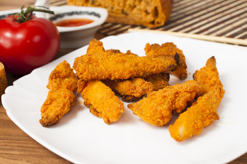 Fried chicken strips with soy sauce.