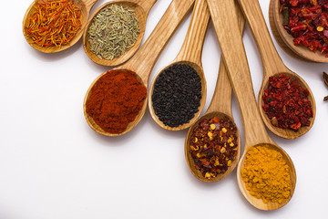 Spice. Spice in a wooden spoon. Herbs. Curry, saffron, turmeric, pepper and other isolated on white background.