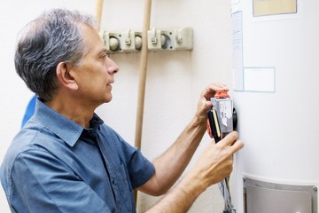 Man checking water heater at vacational rental