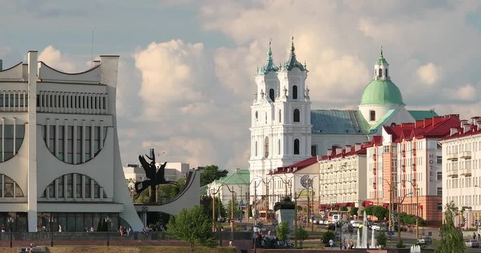 Grodno, Belarus. Grodno Regional Drama Theatre, St. Francis Xavier Cathedral And Traffic In Mostowaja And Kirova Streets In Summer Day
