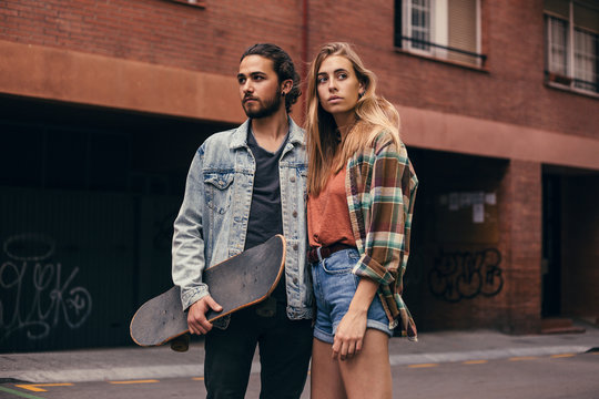 Young urban couple with a skateboard