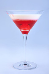 Delicious cocktail with raspberry and cream in martini glass