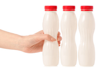 Three plastic white bottles with yoghurt kefir milk in hand