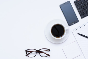 Mixing stationery and gadgets on a white background. View from above.