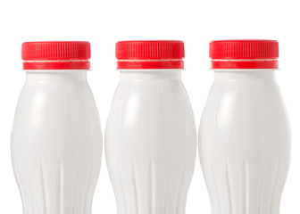 Three plastic white bottles with yoghurt kefir milk