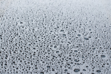 Close up of water drops at a glass table 