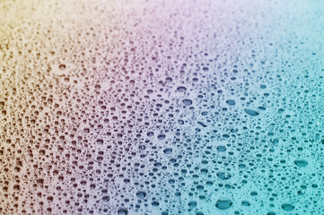 Close up of water drops at a glass table 