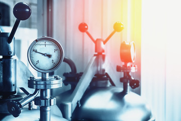 Manometer on steel tank in modern brewery factory, toned, abstract industrial background