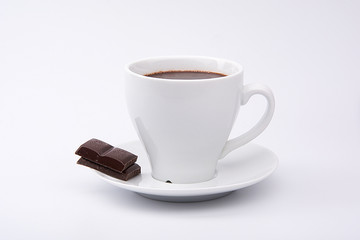 Hot chocolate and chocolate pieces isolated on white background