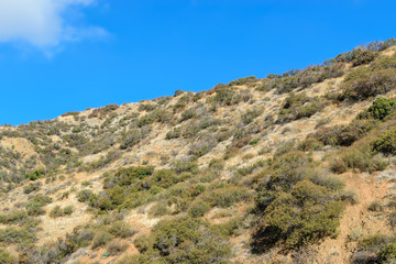 Climbing up the ridge to blue sky on hiking trail