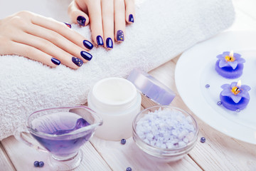 Obraz na płótnie Canvas Beautiful blue manicure with spa essentials