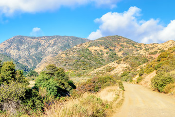 Bright morning sun over hiking trail in mountains