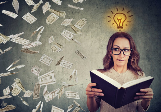 student reading a book has a bright idea how to earn money