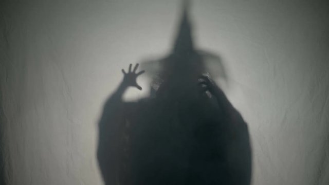 Halloween malefic witch laughing and putting an evil spell on people on halloween day of the dead