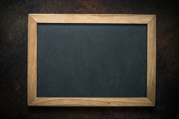 Vintage chalkboard in wooden frame on darke background. 