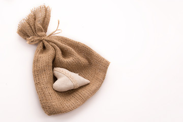 Gift bag made of sackcloth on a white background.