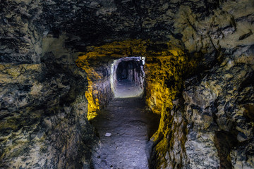 Abandoned and collapsed sandstone or  limestone mine illuminated by color lights