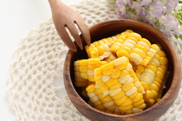 Boiled sweet corn on wooden bolw for healthy food salad ingredient image