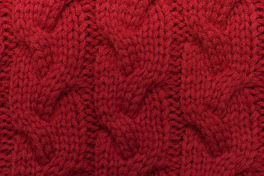 Knitted background. Knitted red texture. A knitting pattern of wool. Knitting. Background.