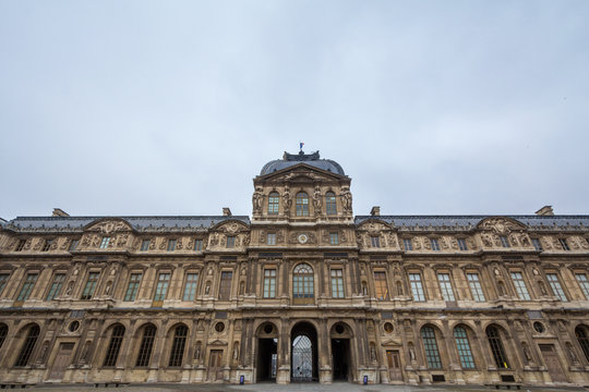 Courtyard of Louvre Palace (Palais du Louvre) in Paris, France, taken during a cloudy afternoon. This former royal palace is now one of the biggest art museums in the world