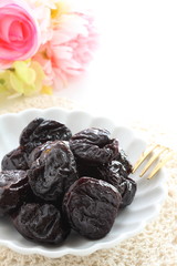 Dried fruit, prune on white dish with copy space for healthy food image
