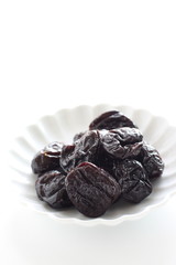 Dried fruit, prune on white dish with copy space for healthy food image