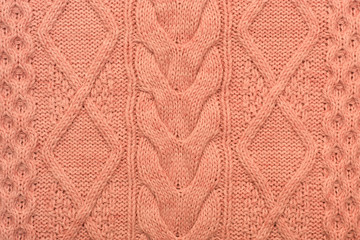 Knitted background. Knitted pink texture. Knitting pattern of wool. Knitting. Background.