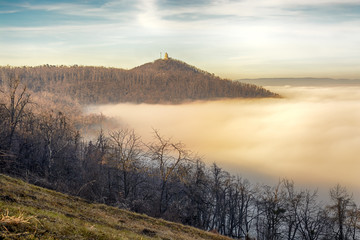 Fototapeta na wymiar János Hill in Budapest with distant Elizabeth Lookout on top. Autumn, fog