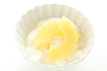 slides of pineapple on yogurt for healthy dessert image