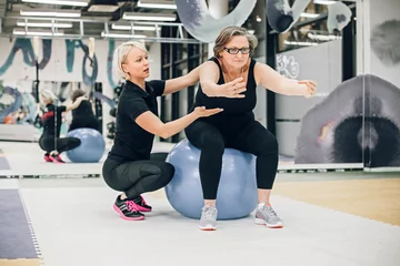 Foto op Plexiglas Senior woman exercising with personal trainer © Svetlana