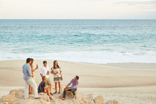Friends having drinking beers on the beach