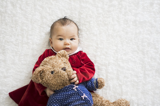 Naklejki Asian baby girl with Teddy Bear