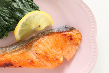 Salmon sauteed served with lemon