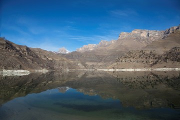 Fototapeta na wymiar Горный пейзаж, живописное озеро в горном ущелье, красивый вид на высокие скалы, природа Северного Кавказа