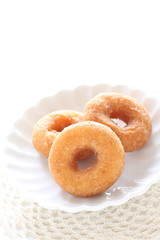 Homemade sugar donut on white dish