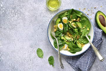 Green salad with boiled quail eggs and walnuts.Top view with copy space.
