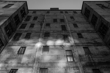 A moody photo looking up at an old drab building