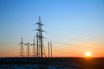 Fototapeta na wymiar Electricity Pylon - power lines overhead power line transmission tower of the sunset.