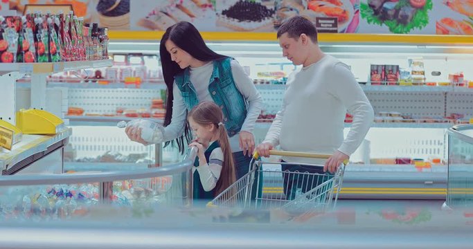 Family takes out frozen food from the fridge them into the trolley