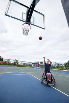 Active disabled athlete practicing wheelchair basketball
