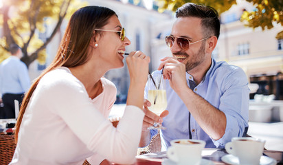Romantic couple drinking coffee, having a date in the cafe. Dating, love, relationships