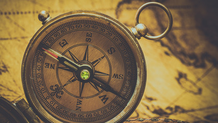 Fototapeta na wymiar Vintage Compass On Ancient Map