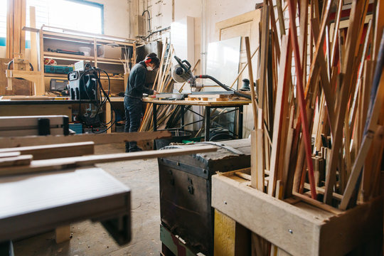 Female Carpenter Working in Bright Carpentry Workshop