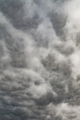 The vertical view of overcast texture with clouds. Copy space.A lot of clouds in dramatic filter.