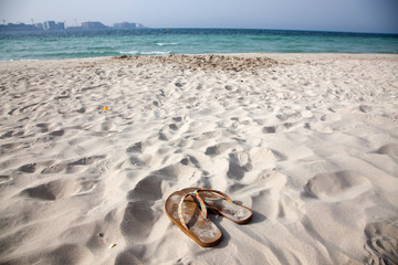 flip flops on sandy beach