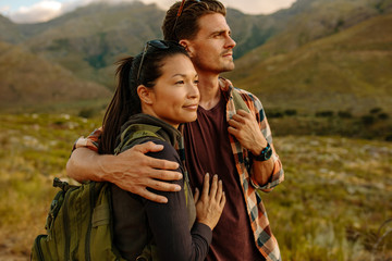 Loving young couple on hiking trip in nature