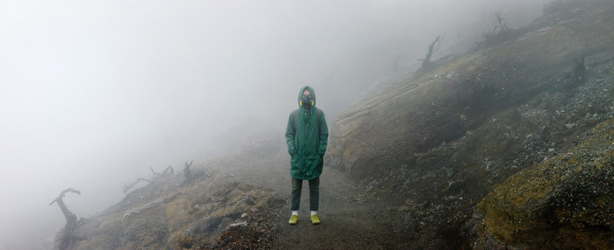 Person silhouette in mists of volcano