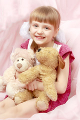 Little girl with a teddy bear.