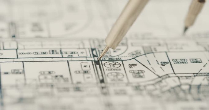 Macro shooting of the compass drawing a round on the chart with numbers. Close up